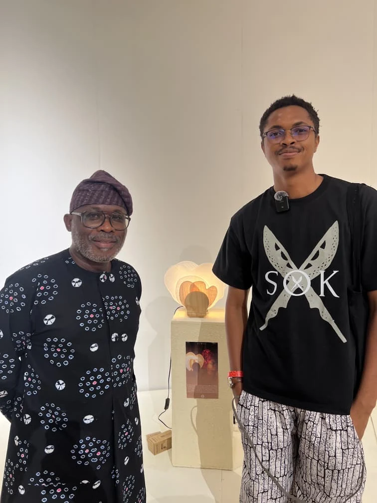 The designer with a visitor beside Diba-Gele at the exhibition